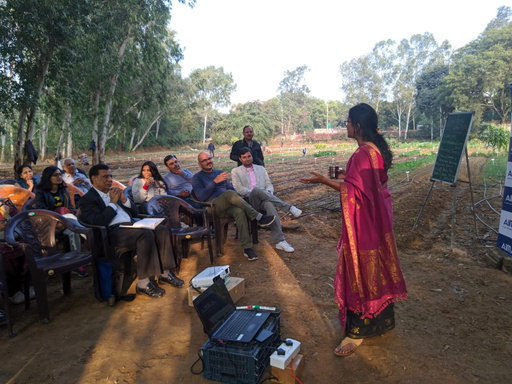 Group gathered around soil samples for a hands-on workshop